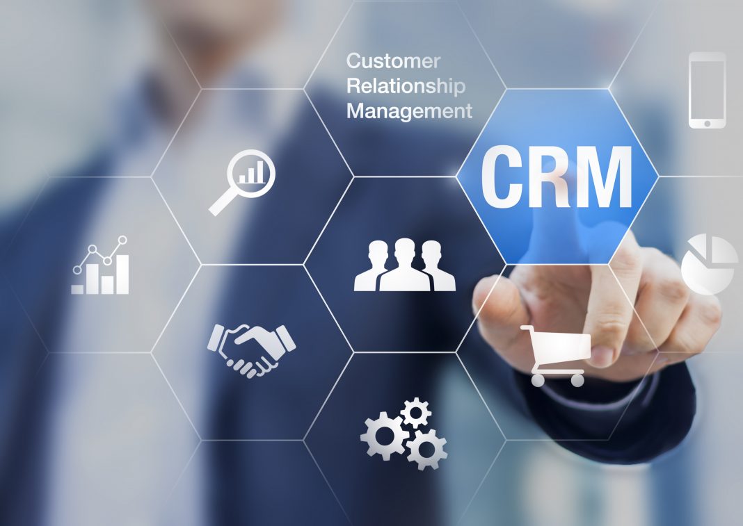Customer relationship management concept with businessman touching button in background