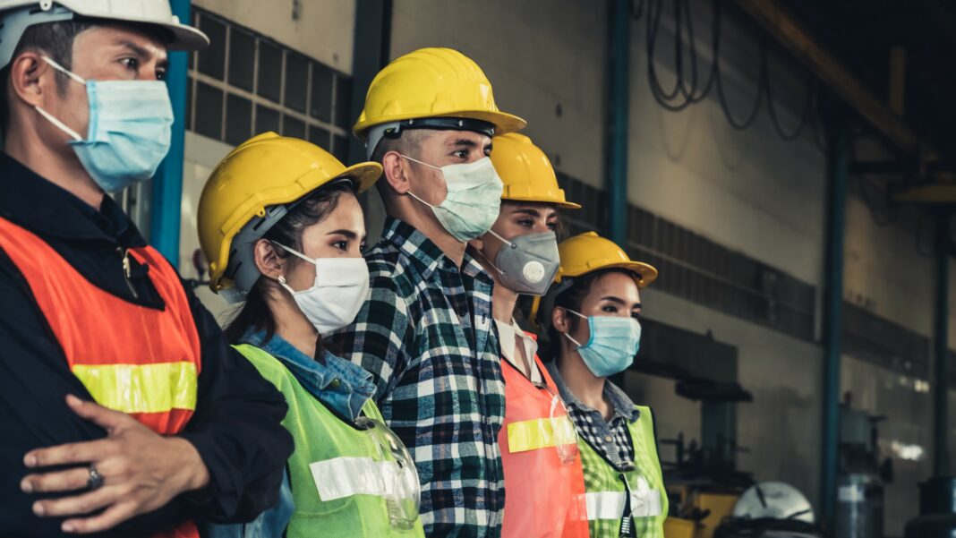 Factory workers with face mask protect from outbreak of Corona Virus Disease 2019 or COVID-19.